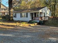 Charming single-story home with white siding, black shutters, inviting deck, and a gravel driveway at 2122 Hope Dr, Rock Hill, SC 29730