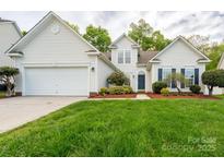 Charming single-Gathering home featuring a well-manicured lawn, a two-car garage, and a traditional white exterior at 2684 Sunberry Nw Ln, Concord, NC 28027