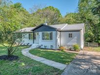 Charming single-story home featuring a landscaped yard and neutral paint at 2717 Springway Dr, Charlotte, NC 28205