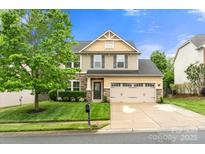 Charming two-story home with stone accents, a well-manicured lawn, and a spacious two-car garage at 3039 Keswick Ter, Indian Land, SC 29707