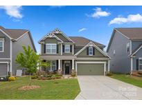 Charming two-story home with a well-manicured lawn and inviting curb appeal, painted in a neutral green tone at 3129 Burnello Ct, Iron Station, NC 28080