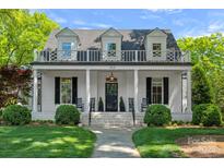 Charming two-story white brick home with a welcoming front porch and manicured lawn at 503 Walnut St, Davidson, NC 28036
