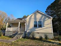Charming single-Gathering home featuring a covered front porch and neutral siding, inviting and well-maintained at 83 Tribune Sw Ave, Concord, NC 28025