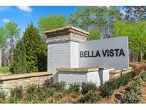 Community entrance sign for Bella Vista featuring brick pillars and manicured landscaping at Lot#143 Norwood Ct, Denver, NC 28037