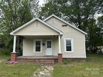 Charming single-story home with a covered front porch and a well-maintained lawn at 110 E Church St, Dallas, NC 28034