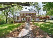 Charming brick home with manicured lawn and inviting stone walkway leading to the front entrance at 122 Corban Se Ave, Concord, NC 28025