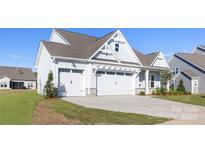 Charming home with a three car garage, stone accents, and a well-maintained lawn at 13279 Arnold Palmer Cir # 867, Lancaster, SC 29720