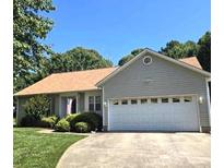 Charming single-story home with a well-maintained lawn and a spacious two-car garage at 317 Robert Keever Rd, Stanley, NC 28164