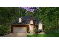 Charming brick home featuring a two-car garage, arched windows and manicured landscaping at 4516 Stryker Dr, Matthews, NC 28104