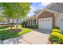 Charming home featuring a one car garage, a stone facade, and beautiful landscaping and manicured lawn at 512 Park View Dr, Belmont, NC 28012