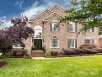 Charming two-story brick home with a manicured lawn and beautiful landscaping at 5621 Landale Ct, Concord, NC 28027