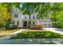 Charming two-story home features a landscaped yard, covered porch, and three car garage at 5868 Savona Ter, Fort Mill, SC 29708