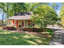 Charming home featuring beautiful landscaping and a welcoming front porch at 101 Blueberry Hill Dr, Statesville, NC 28625