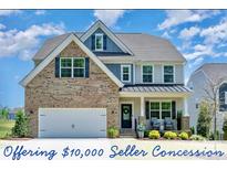 Charming two-story home with brick accents, manicured lawn, and inviting front porch seating at 17231 Rider Wood Ln, Charlotte, NC 28278
