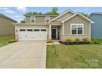 Charming two-story home featuring a two-car garage, tidy landscaping, and inviting brick-accented facade at 179 Bezelle Ave # 34, York, SC 29745