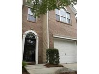 Charming brick townhome features a black front door and a one car garage at 5310 Glenlea Walk Ln, Charlotte, NC 28216