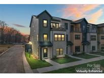 Modern townhome showcases striking architecture and professional landscaping, enhancing its curb appeal at 706 Falling Oak Aly # 16, Huntersville, NC 28078