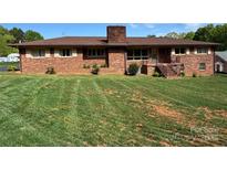 Charming brick home featuring well-maintained landscaping and a classic design at 1012 Burrage Ne Rd, Concord, NC 28025