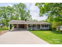 Charming single story brick home with a covered front porch, carport, and well-manicured lawn at 111 Peoria Ln, Kings Mountain, NC 28086