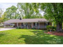 Charming brick ranch home with a welcoming front porch and a well-maintained lawn at 111 Peoria Ln, Kings Mountain, NC 28086