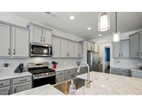 Bright kitchen with stainless steel appliances, modern cabinetry, and a marble countertop island at 1578 Whitman Ct, York, SC 29745