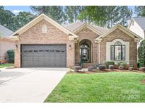 Charming single-story brick home featuring a two-car garage and well-maintained landscaping at 17408 Summer Place Dr, Cornelius, NC 28031