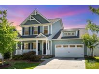 Charming two-story home with a welcoming front porch and a spacious two-car garage at 4406 Huntley Glen Dr, Pineville, NC 28134