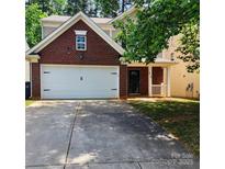 Charming two-story home with a brick facade, a two-car garage, and a well-maintained front yard at 616 Mountain Quail Dr, Charlotte, NC 28216