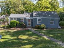 Charming single-story home with a well-manicured lawn and inviting front entrance at 1142 Mona Dr, Charlotte, NC 28206