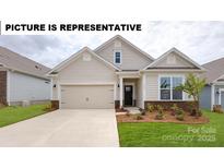 Charming single-story home featuring neutral siding, a two-car garage, and manicured landscaping at 116 S Shayna Rd, Troutman, NC 28166