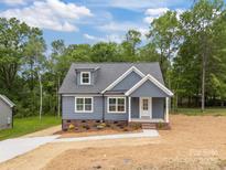 Charming blue home with a well-manicured lawn and inviting front entrance at 130B Springway Dr, Kannapolis, NC 28081