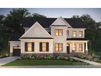 Charming two-story home boasts a landscaped yard, black shutters, and a welcoming front porch at 14012 Camden Close Cir # 35, Huntersville, NC 28078