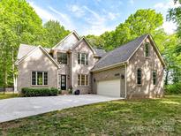 Beautiful two-story brick home with well-manicured lawn and attached two car garage at 1409 Bloomsberry Ln, Waxhaw, NC 28173