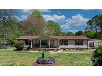 Charming one-story home with a welcoming front porch and a well-maintained yard at 2003 Cape Hickory Cutoff Rd, Hickory, NC 28601