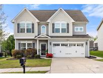Charming two-story home with a well-manicured lawn, neutral siding, and a two-car garage at 2262 Galloway Sw Ln, Concord, NC 28025