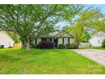 Charming single-story home with lush green lawn, mature trees, and a cozy, inviting facade at 2290 Kestrel Dr, Rock Hill, SC 29732