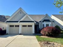 Charming home featuring a two-car garage and manicured front yard, offering great curb appeal at 536 Wellbourne Nw Ct, Concord, NC 28027