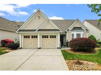 Charming home featuring a two-car garage, manicured lawn, and beautiful landscaping at 536 Wellbourne Nw Ct, Concord, NC 28027