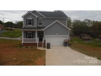 Charming two-story home featuring a well-manicured lawn and inviting front porch at 574 30Th Avenue Ne Cir, Hickory, NC 28601