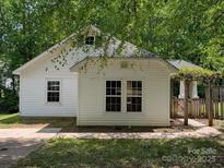 Charming home featuring a bright exterior, traditional windows, and an inviting pergola entrance at 8332 Highlander Ct, Charlotte, NC 28269