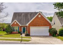 Charming single-story brick home with a manicured lawn and a two-car garage at 269 Tradition Way, Rock Hill, SC 29732