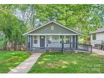 Charming bungalow with a welcoming front porch and lush green lawn, perfect for relaxing outdoors at 2924 Parkway Ave, Charlotte, NC 28208