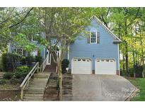 Charming two-story home with a two-car garage and a beautifully landscaped front yard at 4704 Beech Crest Pl, Charlotte, NC 28269