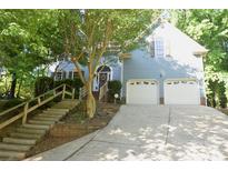 Charming two-story home featuring a two-car garage and landscaped front yard with mature trees at 4704 Beech Crest Pl, Charlotte, NC 28269