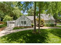 Charming home featuring a well-maintained lawn and a driveway leading to an attached garage at 4931 Pine Ridge Rd, Charlotte, NC 28226