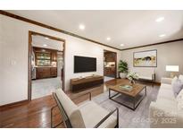 Bright living room with hardwood floors, modern decor, and an open floor plan at 5303 Rogers Rd, Monroe, NC 28110