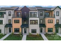 Beautiful modern townhomes featuring a variety of exterior finishes, balconies, and well-maintained landscaping at 714 Falling Oak Aly # 18, Huntersville, NC 28078