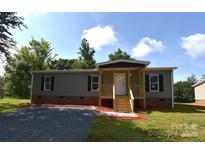 Charming single-story home with a welcoming covered front porch and landscaped yard at 828 Long Bow Rd, Salisbury, NC 28144
