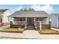 Charming single-story home with a cozy front porch and well-maintained landscaping at 113 Mcgill Nw Ave, Concord, NC 28025