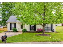 Charming home featuring a well-maintained lawn, mature tree, and inviting curb appeal at 1252 Spring View Ct, Rock Hill, SC 29732